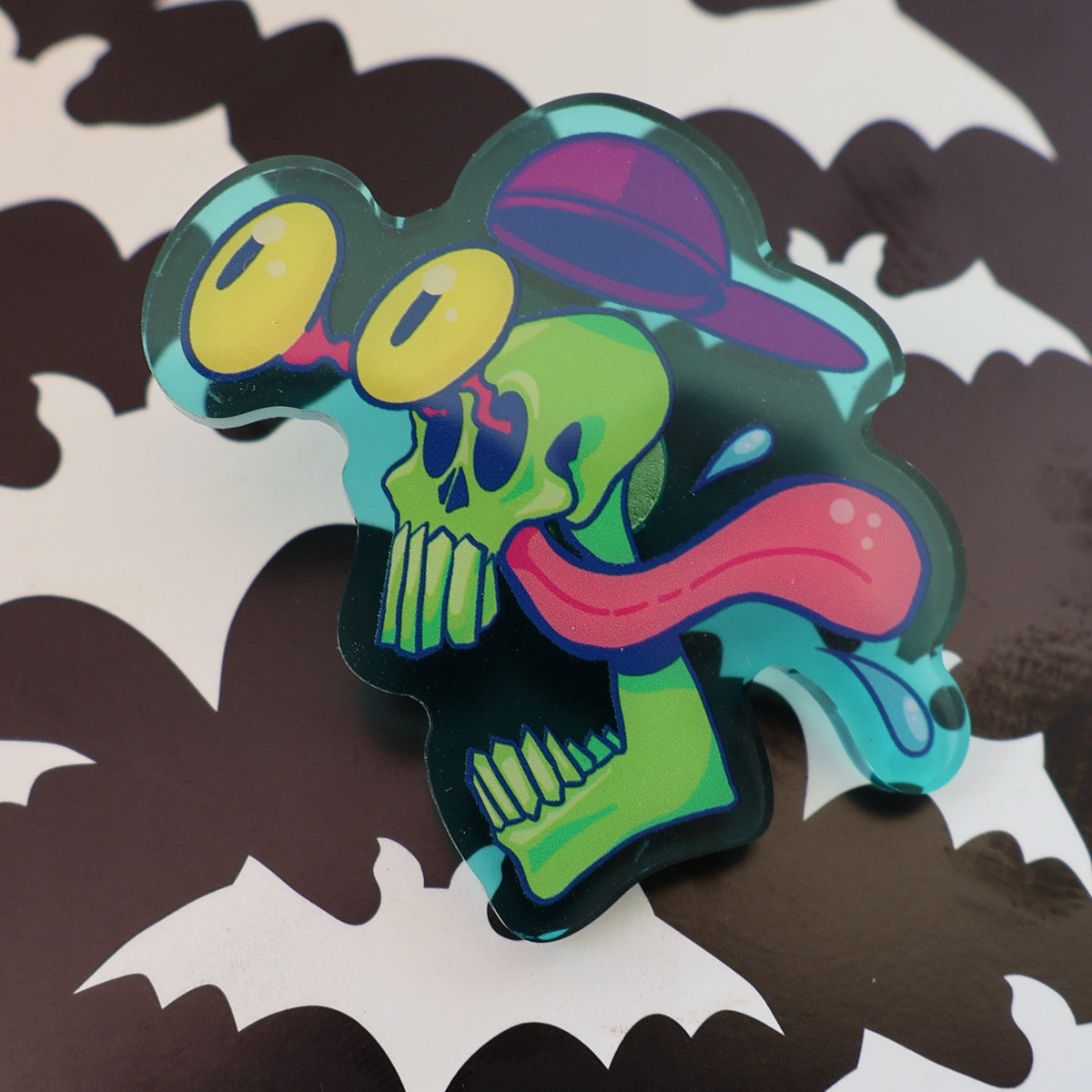 Green Skull with Bug Eyes and Backwards hat, blue/green acrylic pin