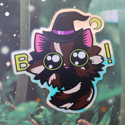Tortoiseshell cat sticker with witch hat and eyes used to spell Boo. Holographic sheen.