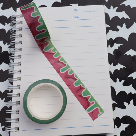 brain motif with retro green drips washi tape on journal with roll sitting nearby