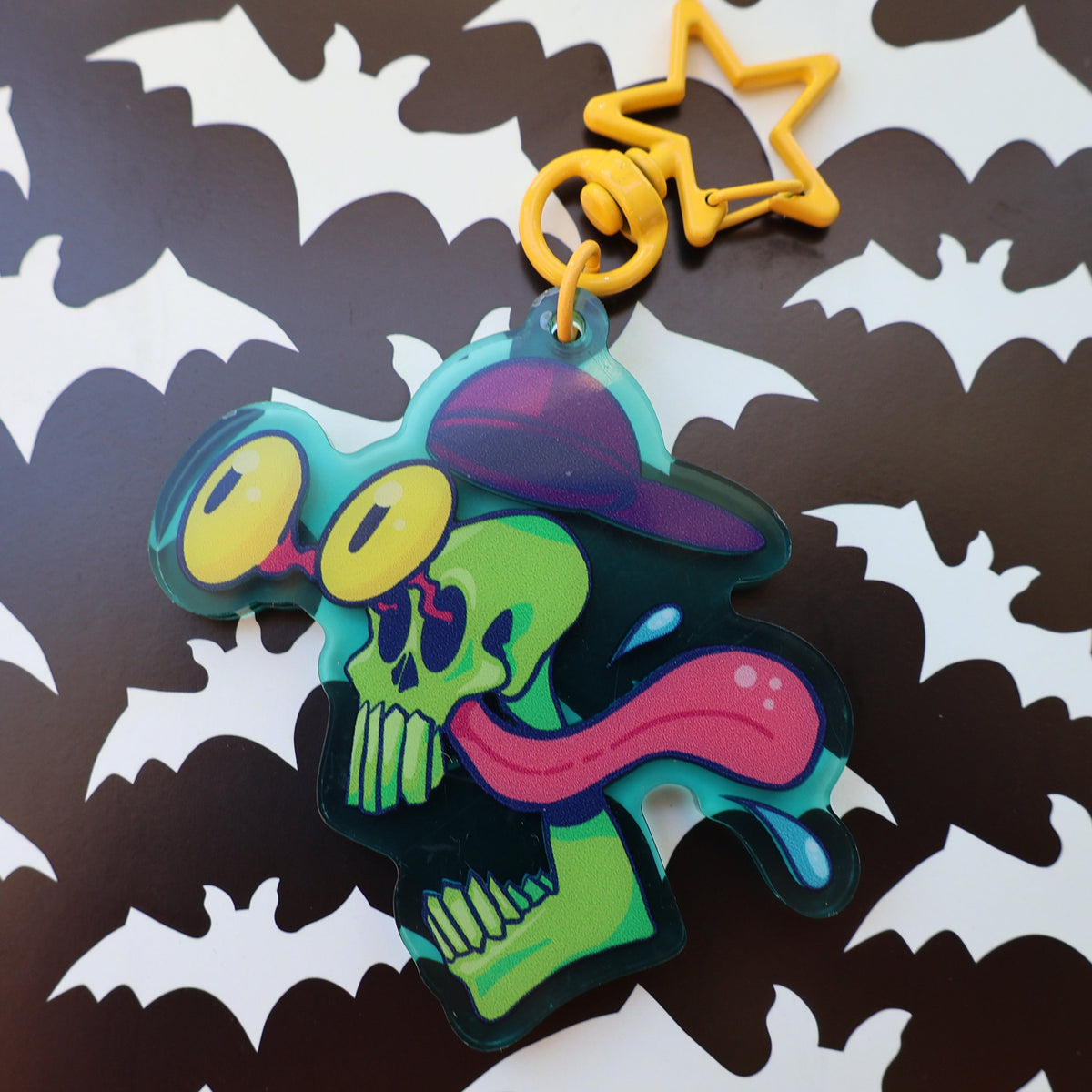 Bug Eyed Green skull with backwards hat, yellow star clasp, keychain charm