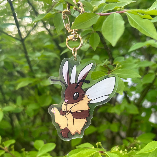  bee and bunny merged keychain hanging from a tree branch