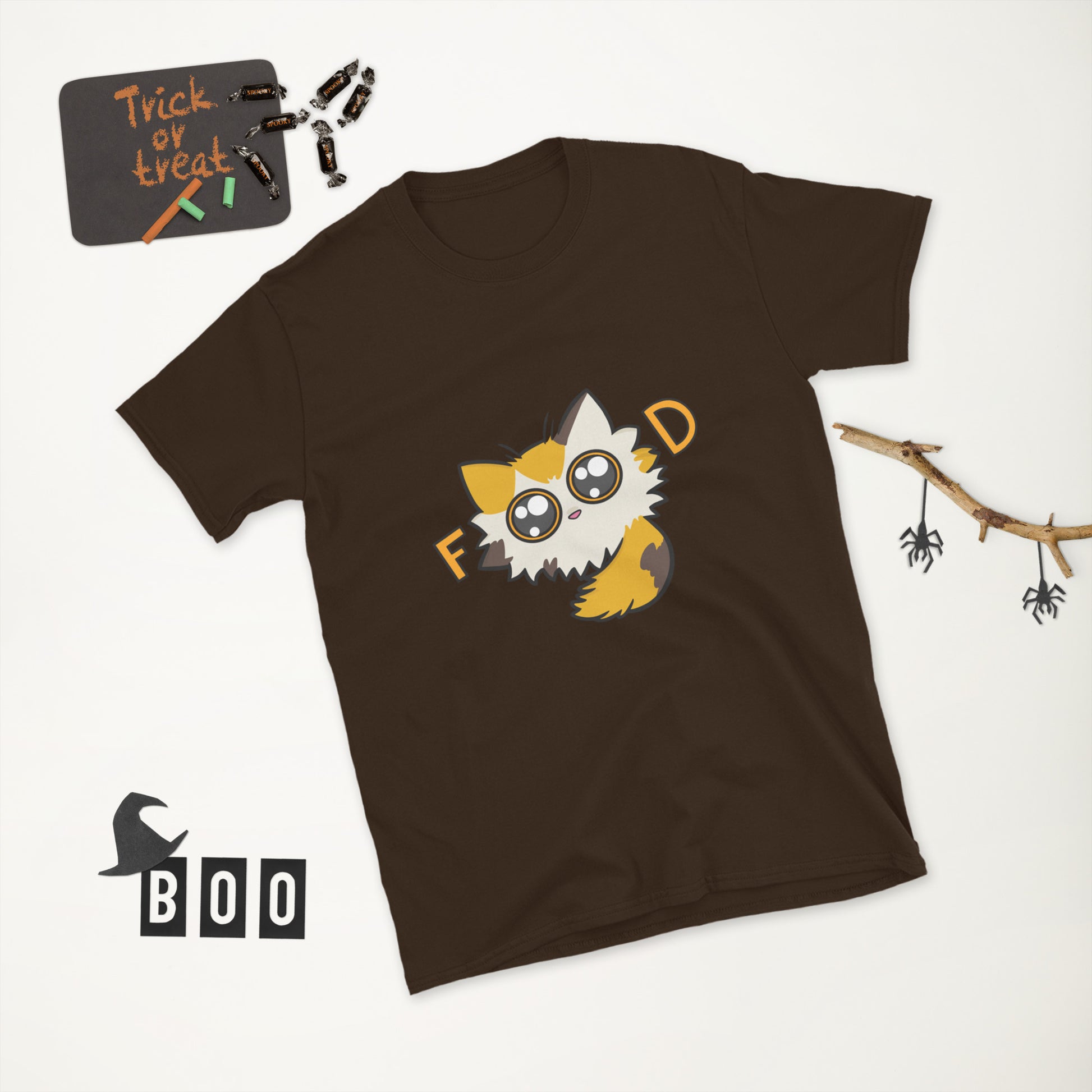 Brown t-shirt with a cartoon cat design and 'Trick or treat' sign on a white background