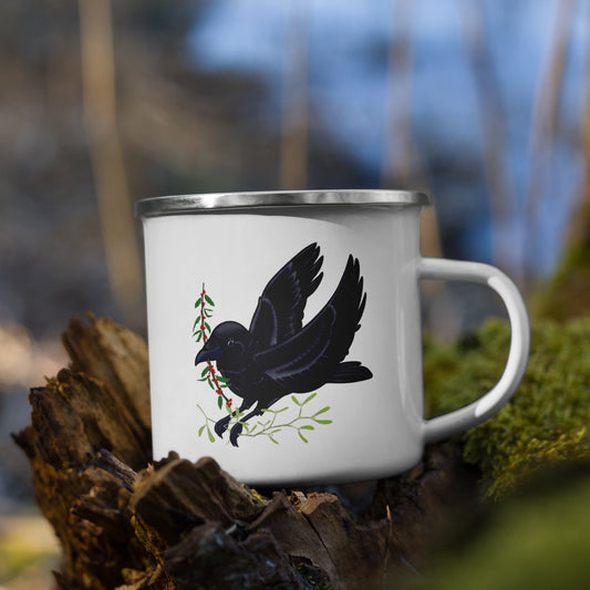White enamel mug with a black crow design on a natural background