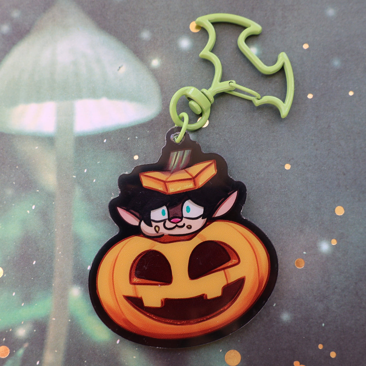 gremlin character popping out of a jack o lantern, light green bat clip on keychain