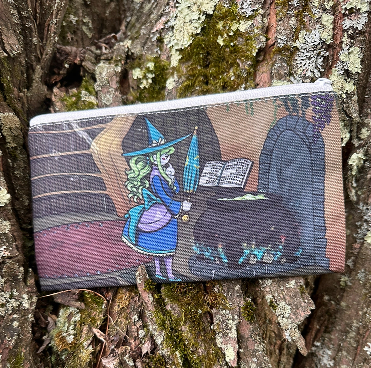 Pencil case with witch design on a tree branch