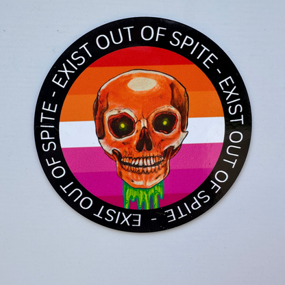 Round magnet with a skull over a lesbian pride flag encircled by the text exist out of spite