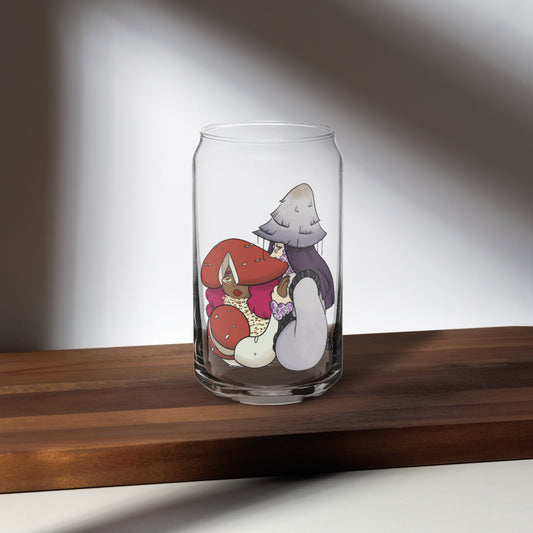 Clear glass can with cartoon mushroom characters design on a wooden surface