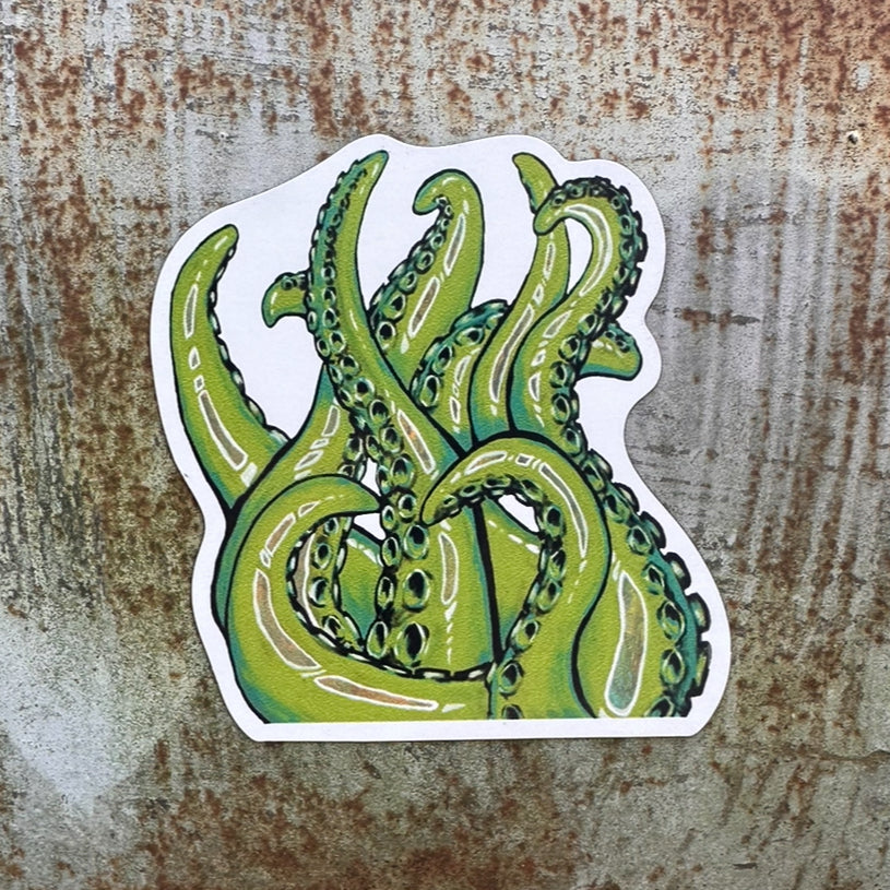 Green waving tentacles magnet on a metal sheet outside.